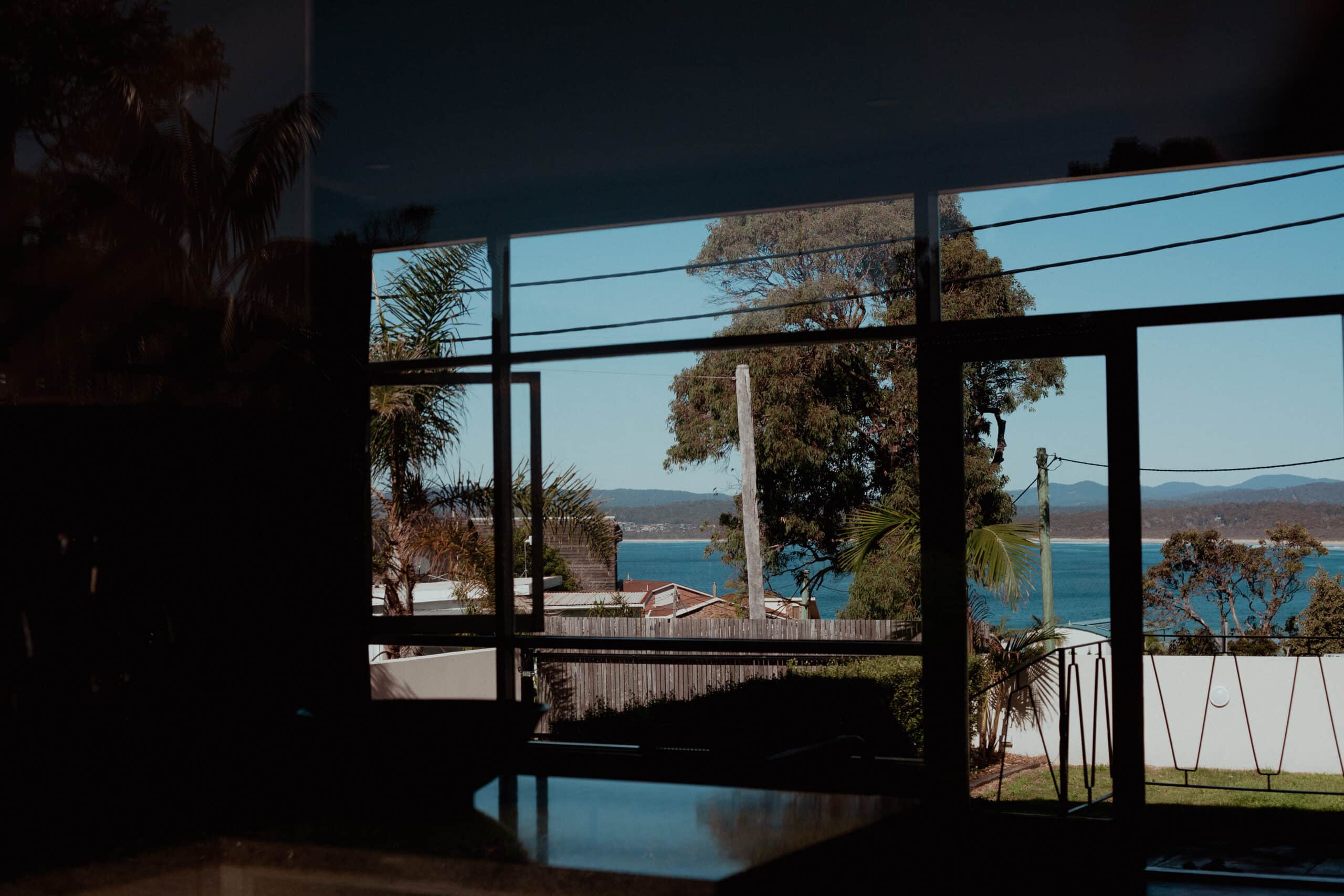 Beach seen through door from Merimbula accommodation