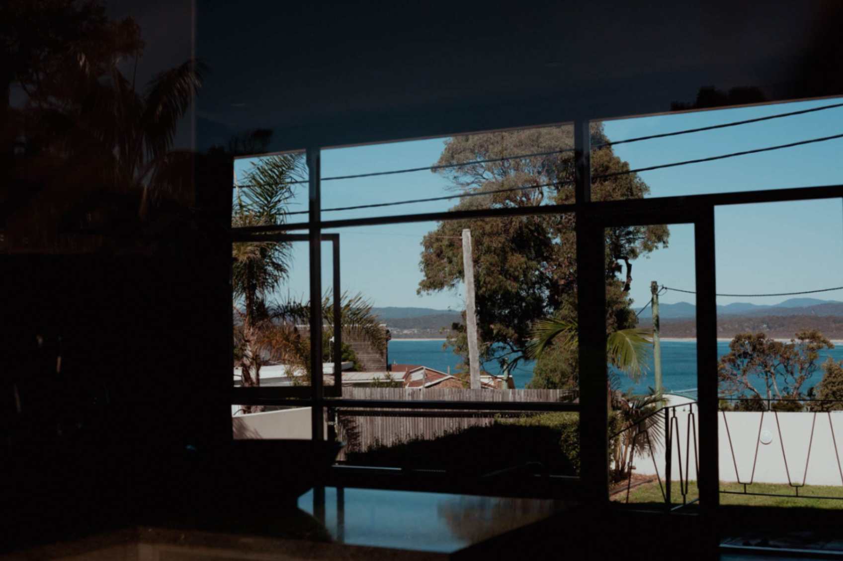 Beach seen through door from Merimbula accommodation
