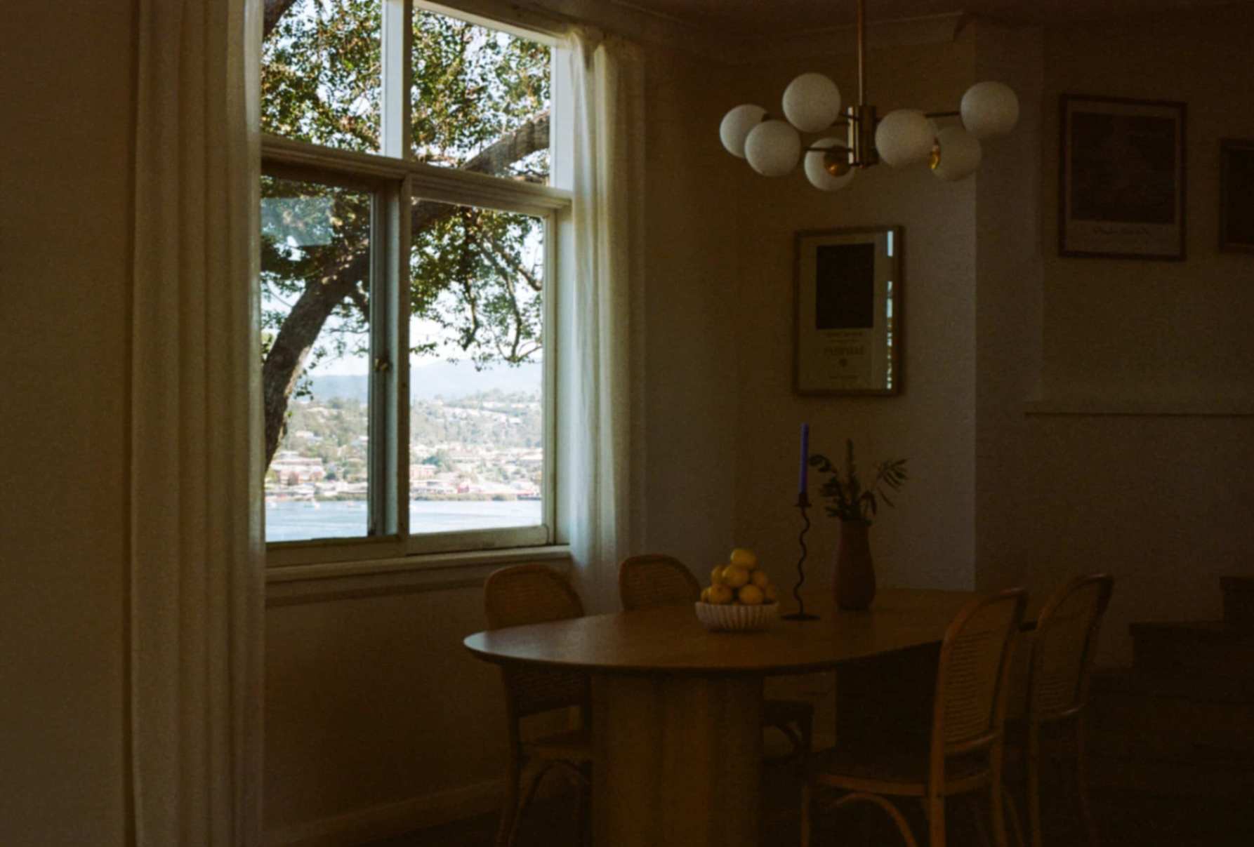 Interior with bowl of fruit on table with chairs in Doma Short Point, A Merimbula Holiday Rental