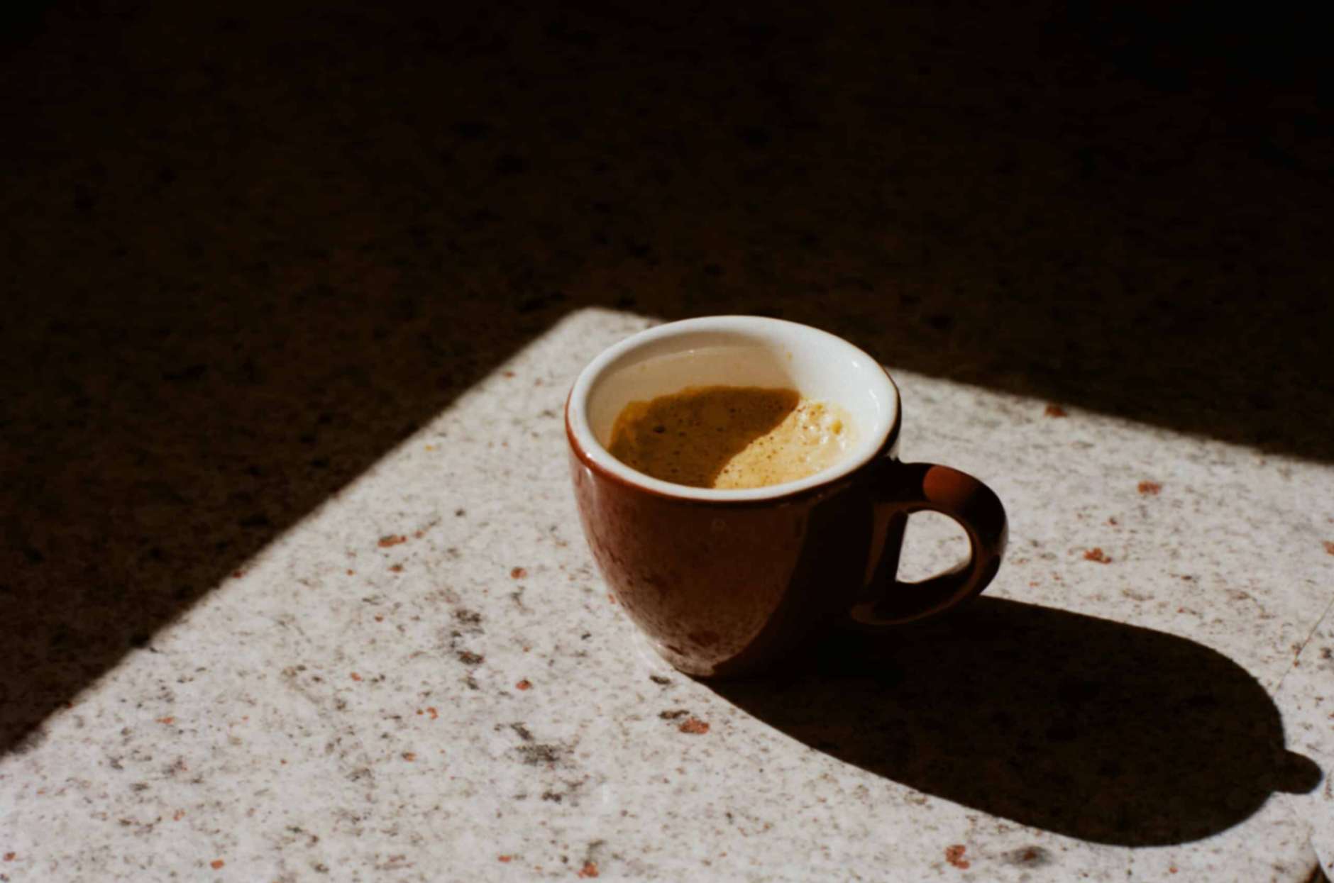 Cup of coffee in brown mug on table at our Merimbula accommodation